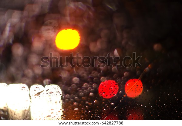 Bad visibility when drunken drive in rainy\
night, blind vision concept, blurred abstract bokeh from spot of\
light as background