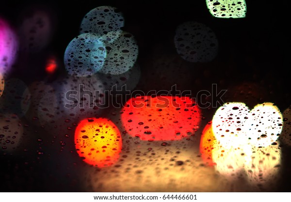Bad visibility when drunken drive in rainy\
night, blind vision concept, blurred abstract bokeh from spot of\
light as background
