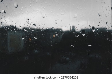 Bad Weather In The City. Buildings, Houses, Cars Outside The Window. Cloudiness Cumulus Clouds. Meteorology And Weather Forecast. Raindrops Run Down The Glass. Storm And Storm And Wind On City Streets