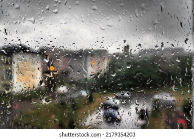 Bad Weather In The City. Buildings, Houses, Cars Outside The Window. Cloudiness Cumulus Clouds. Meteorology And Weather Forecast. Raindrops Run Down The Glass. Storm And Storm And Wind On City Streets