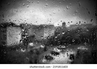 Bad Weather In The City. Buildings, Houses, Cars Outside The Window. Cloudiness Cumulus Clouds. Meteorology And Weather Forecast. Raindrops Run Down The Glass. Storm And Storm And Wind On City