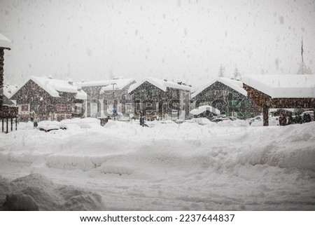 Bad weather and heavy snow in the mountains. Mountain village in winter. Macugnaga, Italy, an important ski resort at the foot of Monte Rosa in the Italian Alps. Main square