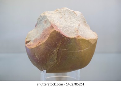 Badajoz, Spain - July 17th, 2019: Middle Paleolithic Biface Or Hand Axe Stone Tool. Archaeological Museum Of Badajoz