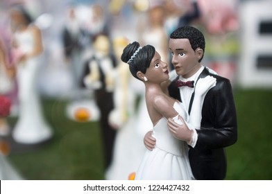 Badajoz, Spain - October 10th, 2018: Wedding Cake Figurine With An African American Bride And Bridegroom Dancing. Selective Focus