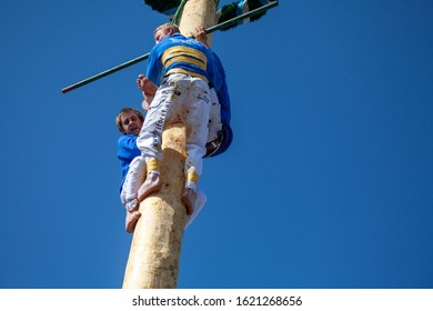 Bad-Birnbach, Bavaria / Germany  - May 01. 2012
Tow Of The Three Mountain Climbers Slide Down The Maypole