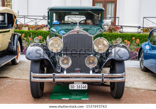 BADEN\
BADEN, GERMANY - JULY 2019: dark green PACKARD DE LUXE EIGHT 904\
Sedan Limousine 1932, oldtimer meeting in\
Kurpark.