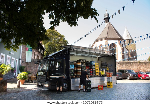 BADEN-WURTTEMBERG, GERMANY - AUGUST 29 : German\
worker working delivery send beer and drink box from truck to\
restaurant and shop at Ladenburg town on August 28, 2017 in\
Baden-wurttemberg,\
Germany