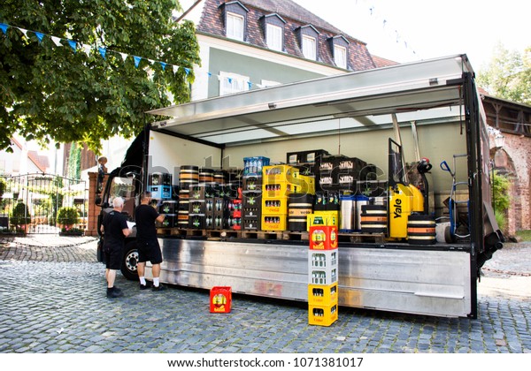 BADEN-WURTTEMBERG, GERMANY - AUGUST 29 : German\
worker working delivery send beer and drink box from truck to\
restaurant and shop at Ladenburg town on August 28, 2017 in\
Baden-wurttemberg,\
Germany