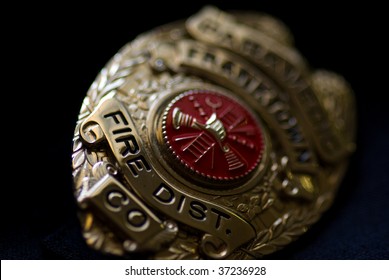 A Badge From A Fire Fighter On A Dark Background