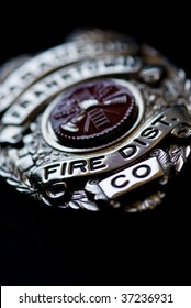 A Badge From A Fire Fighter On A Dark Background