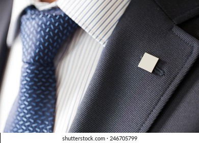 Badge On The Lapel Of His Jacket Men's Shirt With A Blue Tie