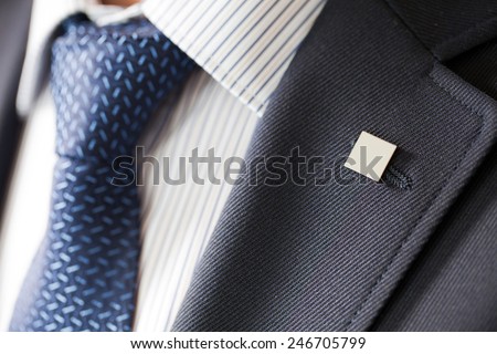 badge on the lapel of his jacket men's shirt with a blue tie ストックフォト © 