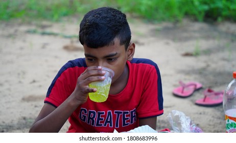 Badhal, Jaipur, India-16 March 2020;
An Cute Indian Kid Taking Cold Soft Drink In Summer Hot Day. Attractive Boy Wearing Red T Shirt. 