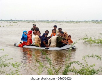 BADIN, PAKISTAN - SEPTEMBER 13: Navy soldiers shift flood-affected people towards safe place on boat at a flooded area due to heavy downpour of Monsoon season in Badin September 13, 2011.