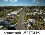 Badly damaged mobile homes after hurricane Ian in Florida residential area. Consequences of natural disaster