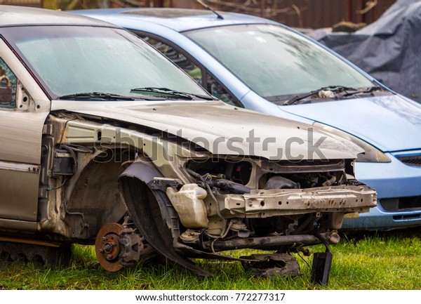 Badly damaged\
rusted car after road\
accident