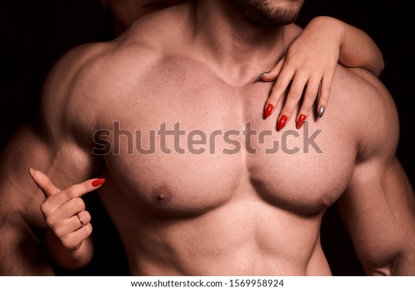 a badly shaven, muscular man. large pectoral muscles.\
a man with a bare torso, athletic build with expressive muscles. a\
healthy lifestyle. a woman\'s hand on a man\'s chest points at\
him