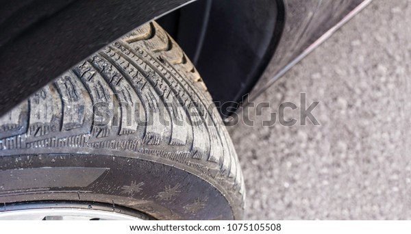 Badly
worn out car tire tread and damaged side due to wear and tear or
because of poor tracking or alignment of the wheels, dangerous for
driving and unsafe, not safe for use. Copy
space.