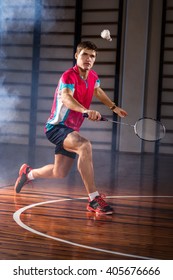 badminton athlete hits a shuttlecock in the gym