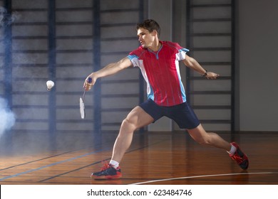 Badminton athlete hits a shuttlecock in the gym