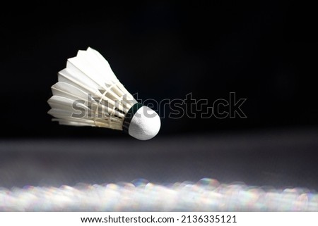 badminton ball floating in black background badminton ball used in competition
