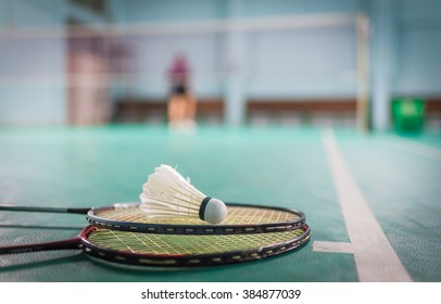 Badminton Ball (shuttlecock) And Racket On Court Floor