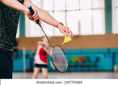 Badminton court with players. Tennis player with a racket. Badminton activity. Sports game of success. Happy kid playing badminton. The child beats the shuttle with a racket.