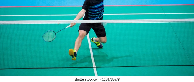 Badminton player beats the shuttlecock in the arena