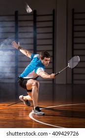 Badminton player beats the shuttlecock in the gym