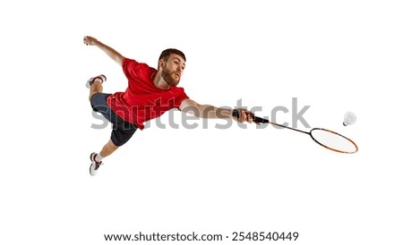 Badminton player in full flight, jumping high with racket poised for winning hit. Graceful movement to get win. Concept of determination and focus during sport game, competition. Ad