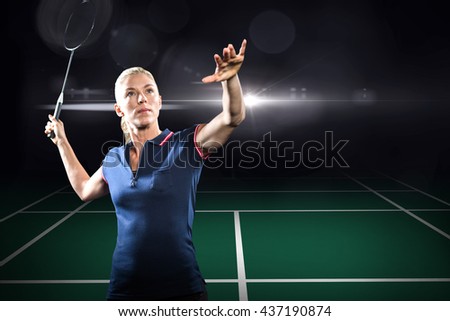 Badminton player playing badminton against view of a badminton field