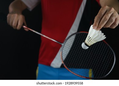 A Badminton Player Postures Back Of The Racket To Serve The Badminton Ball In The Match