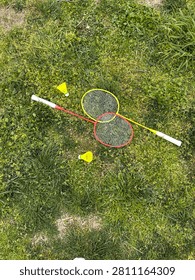 Badminton Rackets and Shuttlecocks Lying on Green Grass
Top view of two colorful badminton rackets with yellow shuttlecocks on fresh green grass. Outdoor sport equipment for summer activity, leisure and healthy lifestyle in a park.
