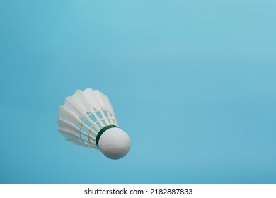 Badminton Shuttlecock Flying On Blue Background