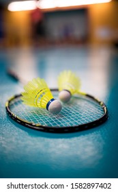 Badminton Yellow Shuttlecock And Racket On Green Floor