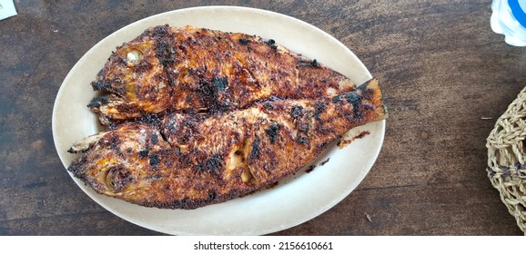 BADUNG - JANUARY 09, 2022:  Grilled Fish On White Plate,burnt With Charcoal. 