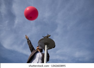 BADUNG/BALI-DECEMBER 07 2017: Weather Man Flies Pink Balloon To Measure Wind Speed And Direction In Every Air Level Under The Blue Sky. In Meteorology, It Is Called Pilot Balloon Observation