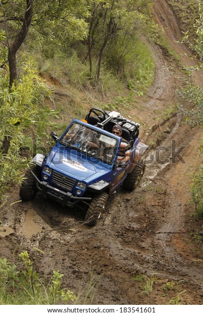 BAFOKENG - MARCH 8: Blue GSMoon 2 Seater Quad Bike\
crossing obstacle at Leroleng 4x4 track on March 8, 2014 in\
Bafokeng, Rustenburg, South\
Africa