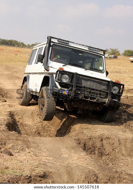 BAFOKENG - MAY 18: White\
Mercedes-Benz G-Class scaling deep holes obstacles at new 4x4 track\
opening event May 18, 2013 in Bafokeng, Rustenburg, South Africa \
