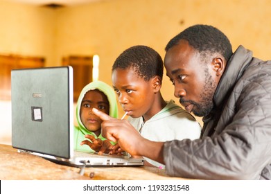 Bafoussam, Cameroon - 06 August 2018: Young African Teacher Involve School Children In Learning Technology With Computer