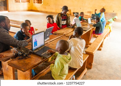 Bafoussam, Cameroon - 06 August 2018: Young African Teacher Involve School Children In Learning Technology With Computer