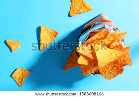 Bag chips doritos pattern top view on blue background