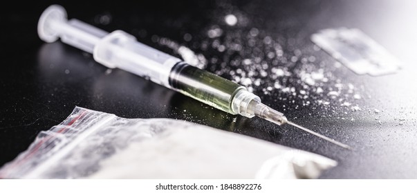 Bag Of Cocaine And Heroin Syringe, Drugs Being Sold And Packaged. Concept Of Trafficking And Sale Of Illegal Substances