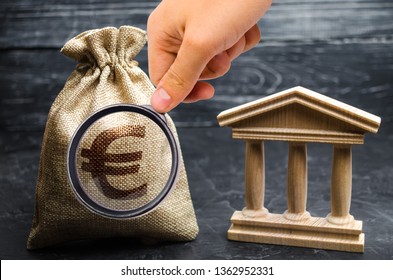 A Bag With Euro Money And A Bank Or Government Building. Deposits, Investment In The Budget. Grants And Subsidies. Payment Of Taxes. Central Bank. Credit Tranches And Leases. Debt Repayment.