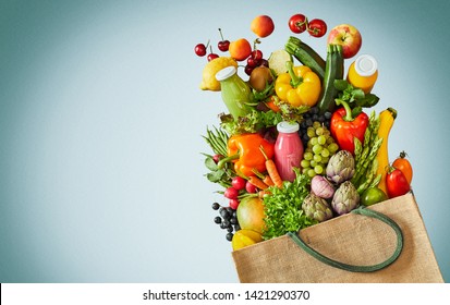 Bag filled with colorful vegetables fruits and glass juice smoothies over white background with blue vignette - Powered by Shutterstock