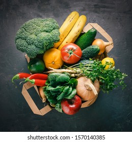 Bag Food Concept.  Paper Bag Raw Vegetables And  Fresh  Fruit On A Dark Background With Copy Space Top View.