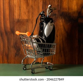 A Bag Full Of Golf Clubs Inside A Shopping Trolley.  