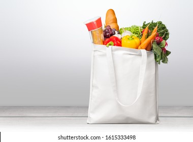 Bag Full Of Groceries On Wooden Desk With Pastel Background