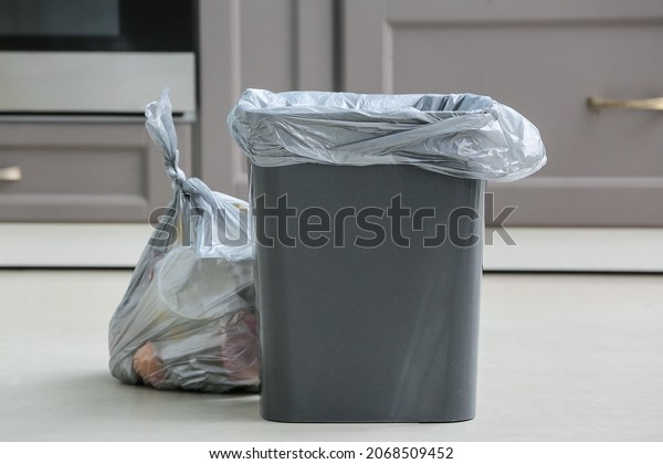 Bag with garbage\
and rubbish bin in kitchen