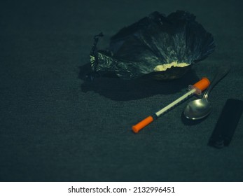 Bag With Heroin, Syringe And Spoon. The Concept Of Narcotic Substance.drug Addiction